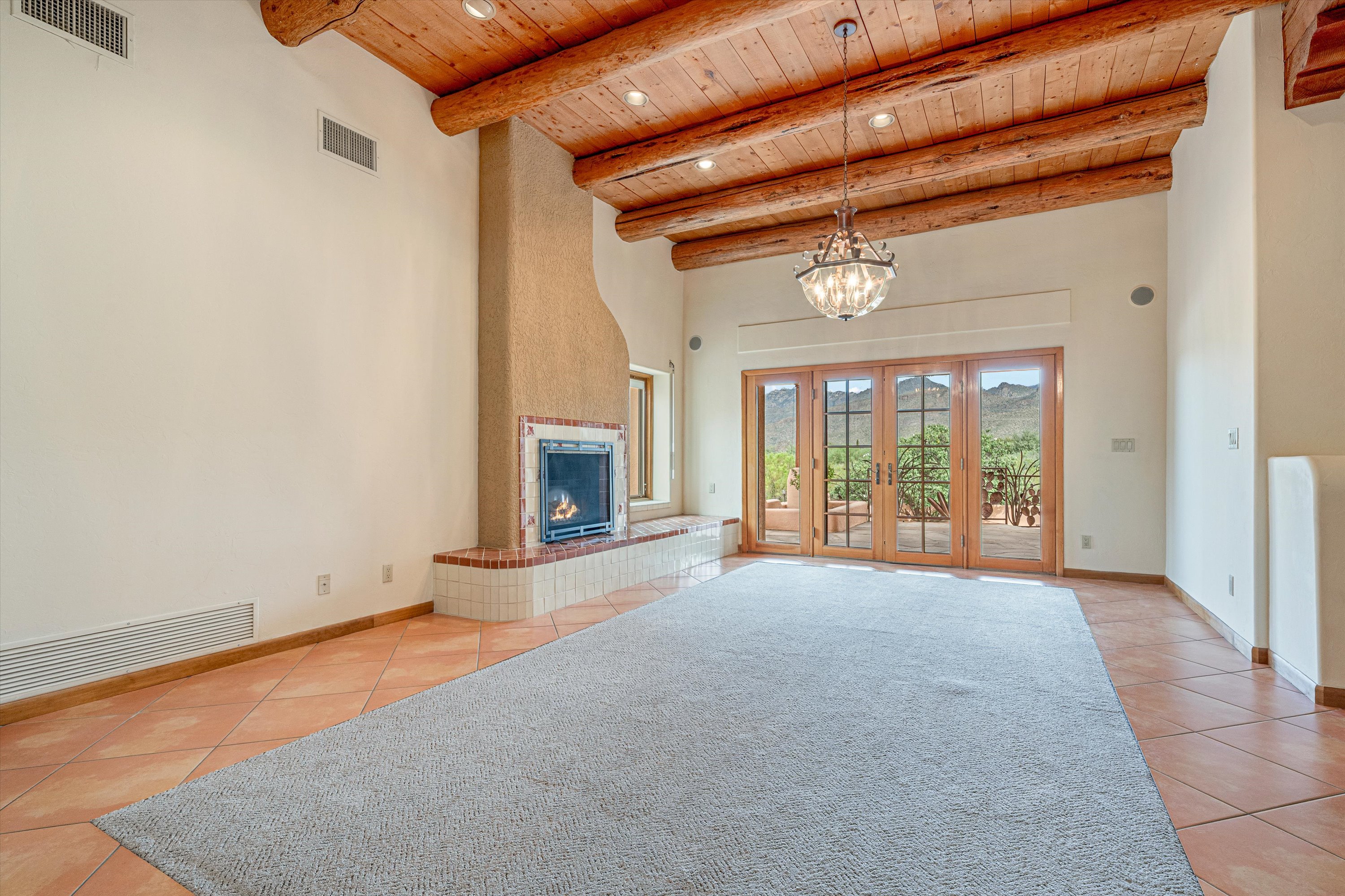 Exposed ceiling beams sourced from Mt. Lemmon bring warmth and authentic Southwestern character to the home.1