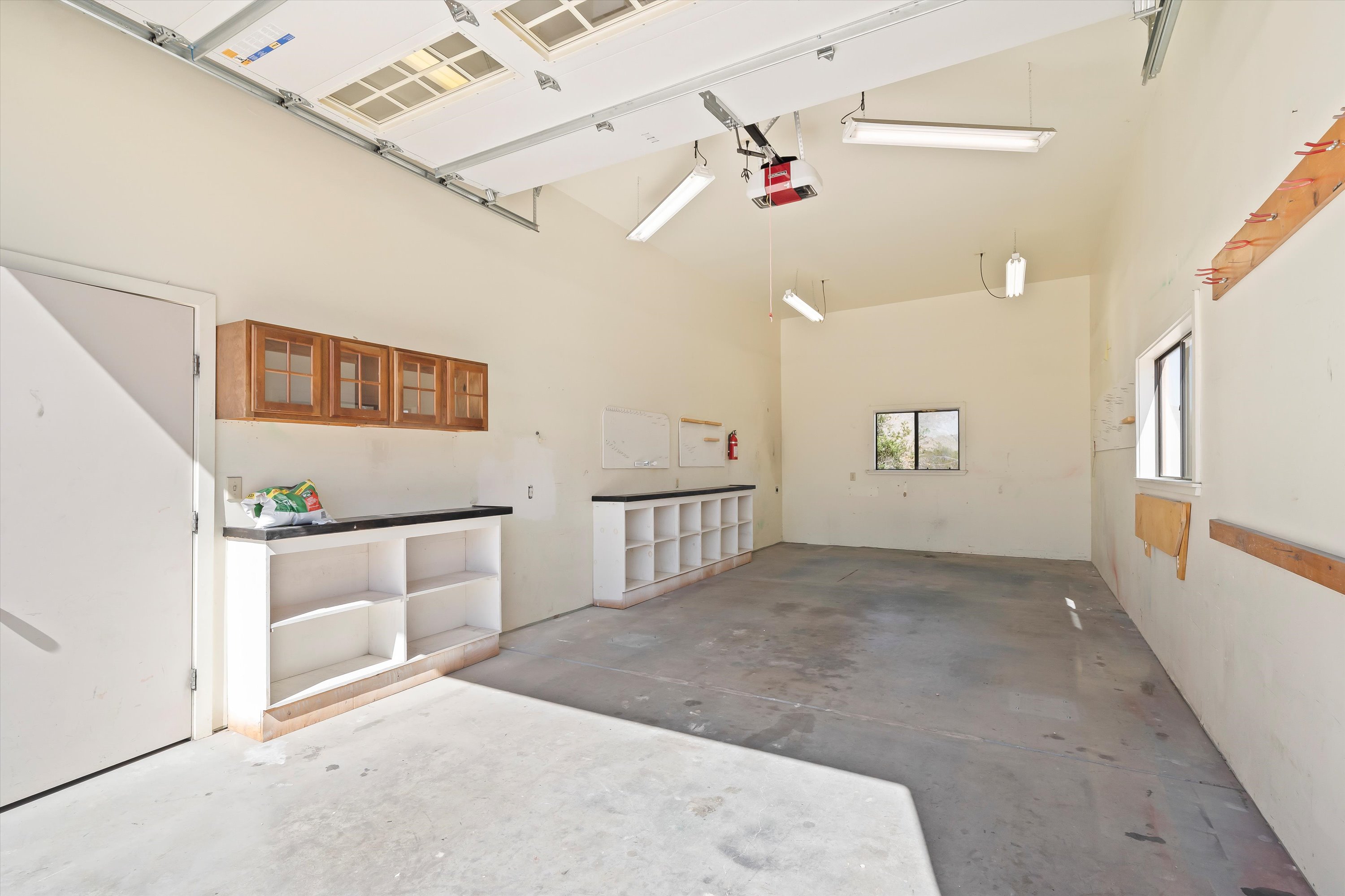 The additional RV garage offers high ceilings, built-in workspace, and room for hobbies, projects, and collections