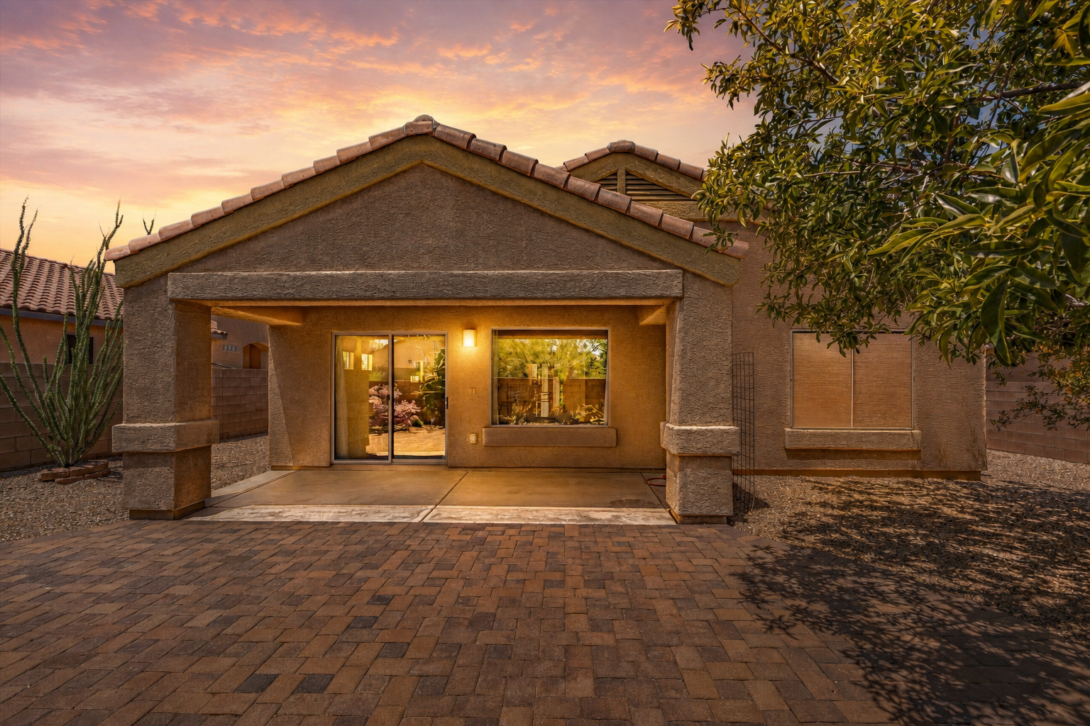 Twilight view of the backyard and covered patio at 513 S Stone Bench Road in Corona de Tucson